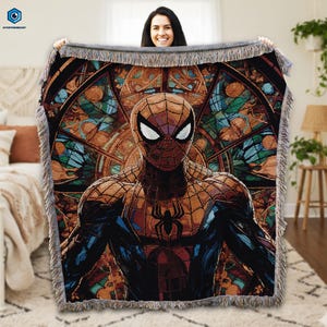 A woman is holding up a large, colorful tapestry featuring a Spiderman character.