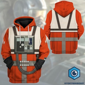 May include: Orange and white hooded sweatshirt with a printed design of a pilot's flight suit. The design includes a chest panel with buttons and a belt.