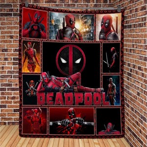 May include: A red and black quilt featuring a collage of images of Deadpool, a fictional superhero. The quilt has a black background with red and white accents. The quilt features the word "Deadpool" in large, bold letters.