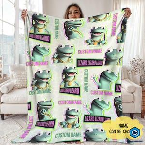 May include: A light green blanket featuring a repeating pattern of cartoon lizards wearing gold chains and bracelets. The blanket has the text "CUSTOM NAME" and "LIZARD LIZARD LIZARD" in various places.