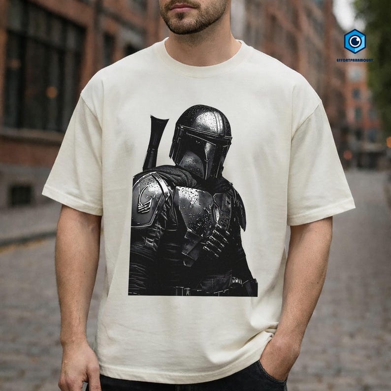 A man wearing a white t-shirt with a black and white image of a character from the Star Wars franchise.