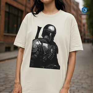 A person wearing a white t-shirt with a black and white graphic of a character from the Star Wars franchise.