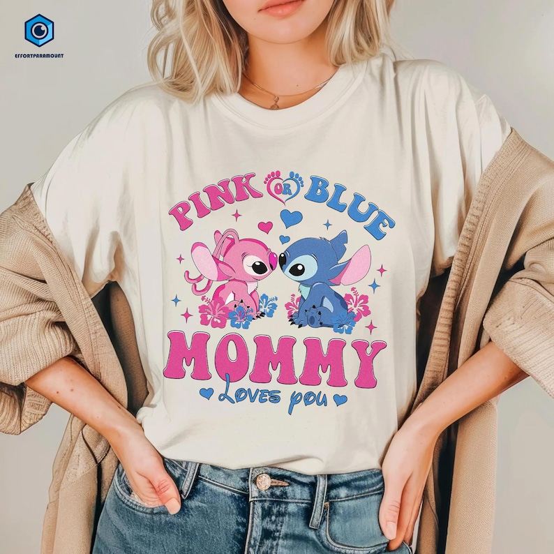 May include: A white t-shirt with a pink and blue Stitch design. The text on the shirt reads "Pink or Blue Mommy Loves You".
