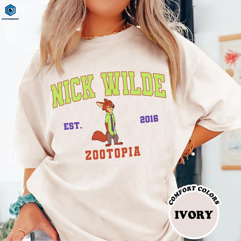 A person wearing a white t-shirt with a graphic of a cartoon character and text printed on it.
