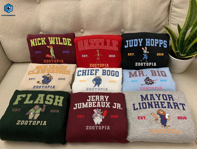 A collection of colorful hoodies or sweatshirts with various animal characters and text, including "NICK WILDE", "GAZELLE", "JUDY HOPPS", "CHIEF BOGO", "MA. BIG", "FLASH", "JERRY JUMBEAU JR.", and "MAYOR LIONHEART".