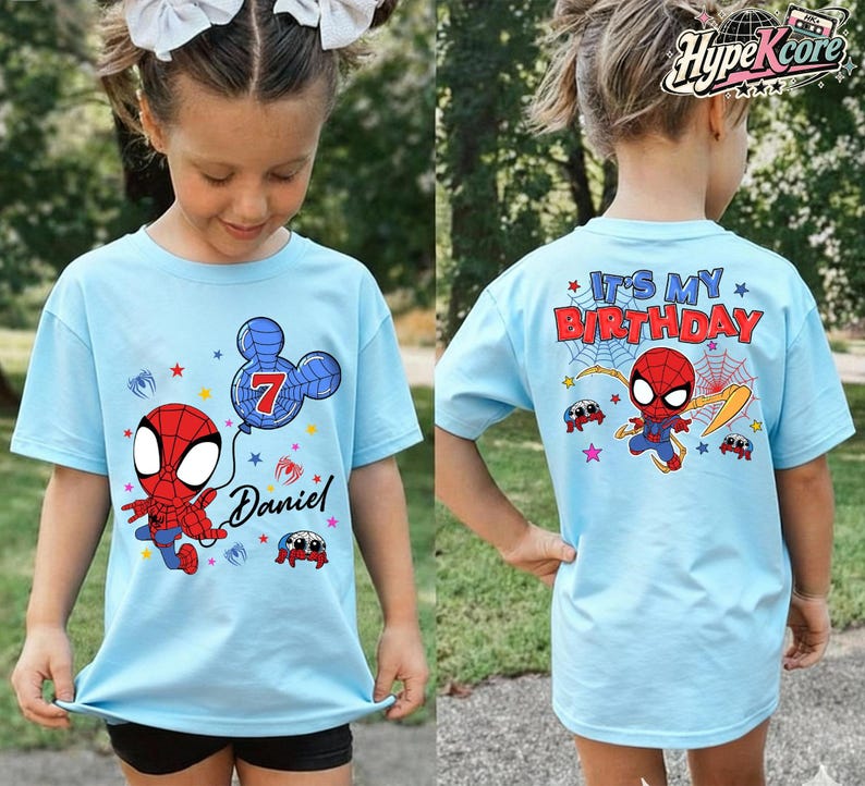 May include: Light blue t-shirts with a Spider-Man theme. The front of the shirt features a cartoon Spider-Man, a balloon with the number 7, and the name "Daniel". The back of the shirt says "It's My Birthday" with Spider-Man and spider web graphics.