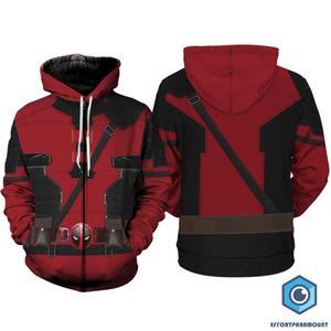 May include: Red and black hooded sweatshirt with a zipper closure and a graphic print of a superhero character. The sweatshirt has a black and red design with a belt and straps.