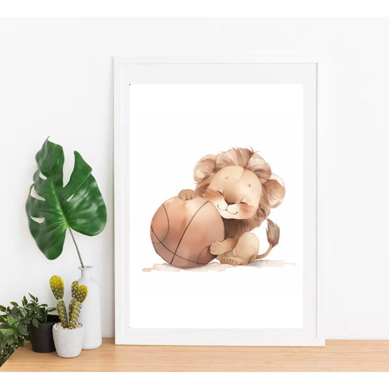 May include: A cute cartoon lion with a brown mane is holding a brown basketball. The lion is smiling and has a happy expression on its face. The background is white.