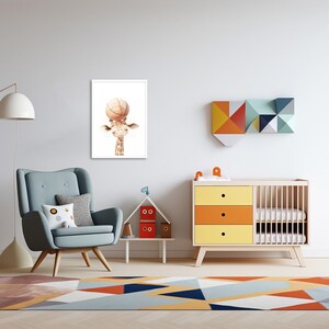 May include: A framed print of a cartoon giraffe holding a basketball above its head. The giraffe is brown with a white face and a light brown neck. The print is on a white background and is framed in a white frame. The print is hanging on a white wall in a nursery.