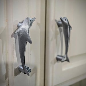 Matching pair of cabinet door pulls - dolphins