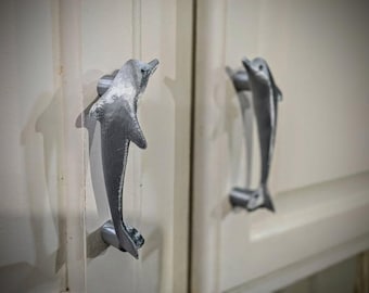 Matching pair of cabinet door pulls - dolphins