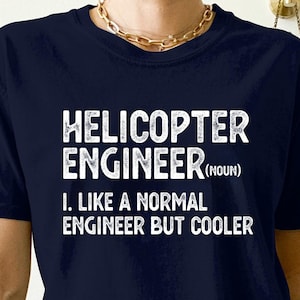 May include: Navy blue t-shirt with white text that reads "Helicopter Engineer (noun). I. Like a normal engineer but cooler."