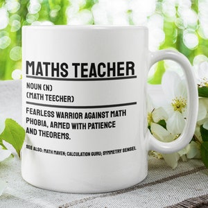 May include: White ceramic mug with a black design that reads "MATHS TEACHER" and defines the term as a "FEARLESS WARRIOR AGAINST MATH PHOBIA, ARMED WITH PATIENCE AND THEOREMS."