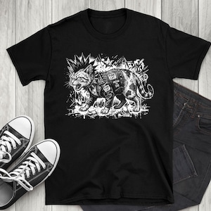 May include: Black t-shirt with a punk cat graphic. The monochrome illustration depicts a cat with a mohawk and leather jacket, with the text "Punk Cat". The shirt is styled with black trainers and dark wash jeans.