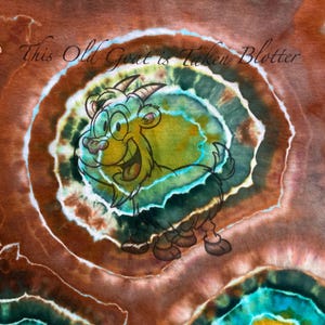 May include: A colorful illustration of a cartoon goat with a smiling expression, set against a tie-dye background of brown, green, and blue hues. The text "This Old Goat is Taken Blotter" is written in a cursive font.