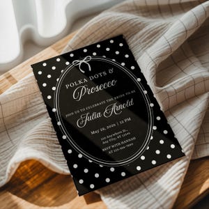 May include: Black and white polka dot invitation with the text "Polka Dots & Prosecco" and "Join us to celebrate the bride to be Julia Arnold". The invitation includes the date, time, and RSVP information.