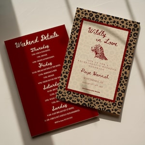 May include: Two rectangular invitation cards with a leopard print border. One card features the text Wildly in Love, a leopard illustration, and event details for Paige Hannah in Scottsdale, AZ. The other card lists a weekend itinerary in white text.