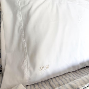 May include: A set of three ceramic mugs with a speckled, matte finish. The mugs are in shades of cream, light gray, and dark gray. Each mug has a simple, minimalist design and a rounded handle.