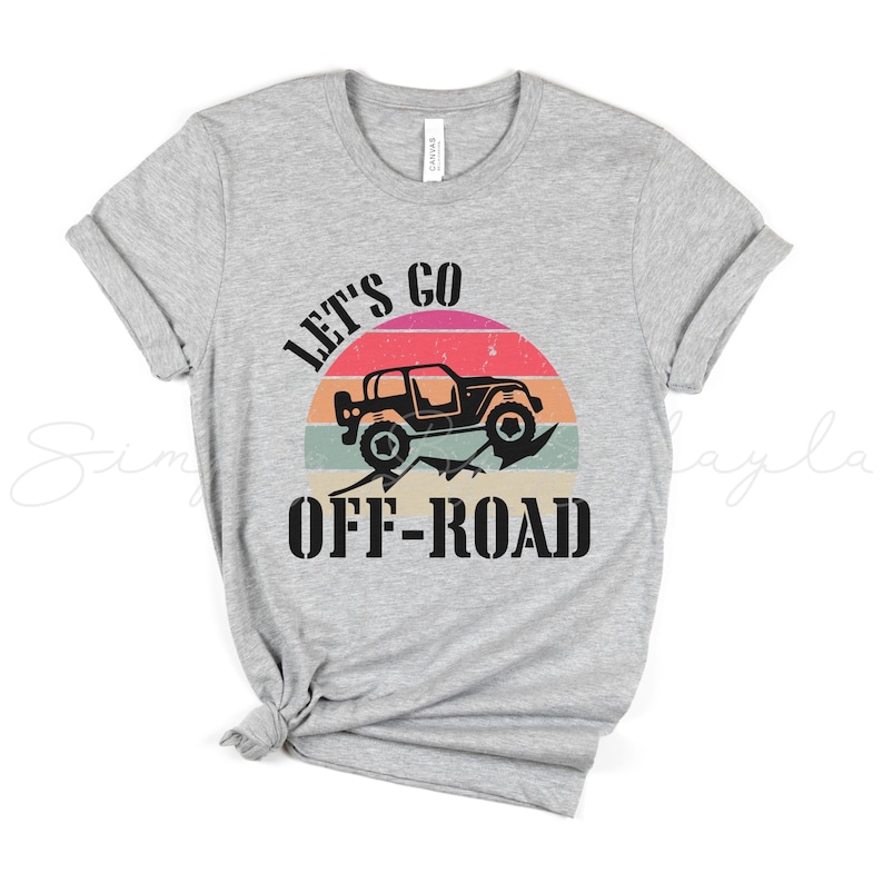 May include: A gray t-shirt with a vintage-style graphic of a jeep driving off-road with the text "Let's Go Off-Road".