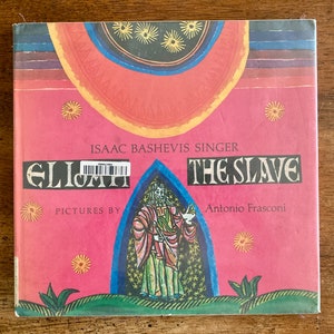 May include: A pink book cover with the title "Elijah the Slave" by Isaac Bashevis Singer. The cover features illustrations of a man in a robe and a star-filled sky.