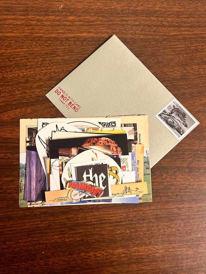 May include: A stack of vintage postcards and ephemera, including a postcard with a photo of a tree, a postcard with a photo of a building, and a postcard with a photo of a person. The postcards are all in various states of wear and tear, and some have handwritten notes on them. The stack of postcards is sitting on a wooden table.