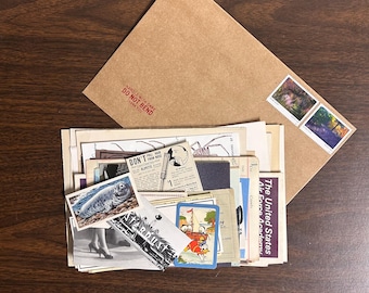 May include: A brown paper envelope with a red stamp that says "HANDLE WITH CARE DO NOT BEND THANK YOU". The envelope is filled with vintage postcards, stamps, and other ephemera.
