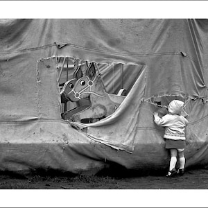 B/W image of a child at a closed carousel in 1976, the photo is of my daughter Victoria, Bolton, Lancashire, England UK © DON TONGE