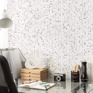 May include: A home office desk with a white lamp, a black leather chair, a white ampersand, a camera, a notebook, a magnifying glass, and a black pencil holder with pencils. The wall behind the desk is covered in a white wallpaper with a black binary code pattern.