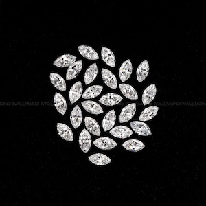 May include: A cluster of marquise-cut diamonds, each with a pointed oval shape, set against a black backdrop. The diamonds sparkle, reflecting light. The arrangement emphasizes the clarity and cut of the gemstones, ideal for jewellery.
