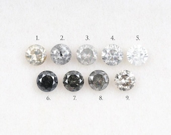 May include: Nine round-cut diamonds of varying colors are displayed against a white background. The diamonds range from light champagne to black and gray, each with visible facets. Numbers 1 through 9 are labeled below each stone.
