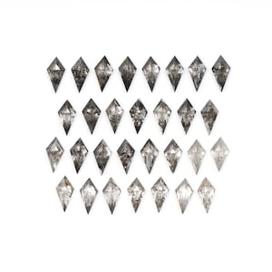 May include: A collection of 27 black diamonds arranged in a grid pattern. The diamonds are faceted and have a dark, smoky appearance.