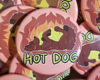 May include: A collection of round, pink buttons with a cartoon dog illustration. The dog is brown and appears to be lying down in flames. The text "HOT DOG" is written in yellow and green.
