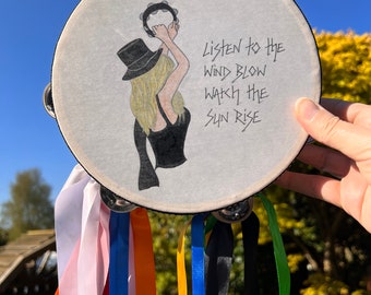 Hand drawn Stevie Nicks onto a tambourine with handwritten lyrics to The Chain. Ribbons attached, Stevie Nicks style!