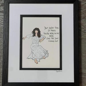 May include: A black and white illustration of a woman dancing with the lyrics "But every time it rains you're here in my head like the sun coming out" and the signature "Moonface".