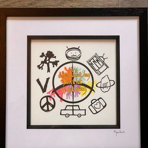 May include: A framed black and white illustration with a colourful circle in the centre. The circle has the text "It's a beautiful day Don't let it get away" written in gold. The illustration includes a peace sign, a car, a tree, a suitcase with a heart, a television, and a robot.