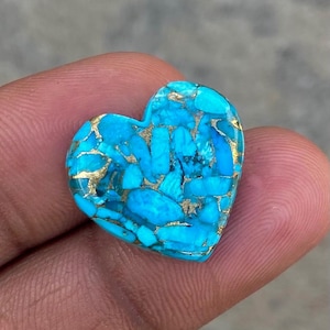 May include: A heart-shaped turquoise cabochon with a blue and gold marbled pattern.