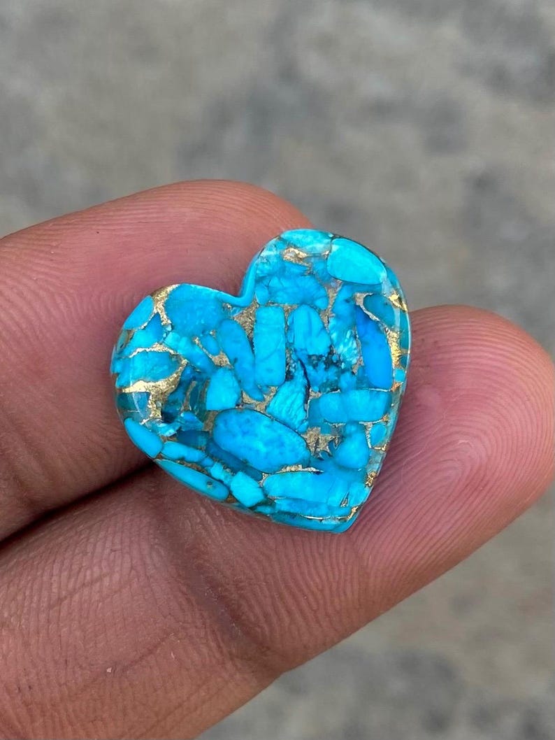May include: A heart-shaped turquoise cabochon with a blue and gold marbled pattern.