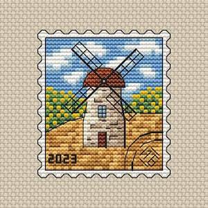May include: A vintage-style postage stamp with a brown windmill against a blue sky with white clouds. The windmill is in a field of yellow and green crops. The stamp has the year 2023 printed on it.