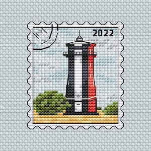 May include: A vintage-style postage stamp with a black and white lighthouse with a red stripe, surrounded by green bushes and a sandy beach. The stamp has a black border and the year 2022 printed in the top right corner.