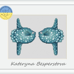 May include: Cross stitch pattern featuring two blue and white ocean sunfish facing each other. The pattern is titled "Kateryna Besperstova".