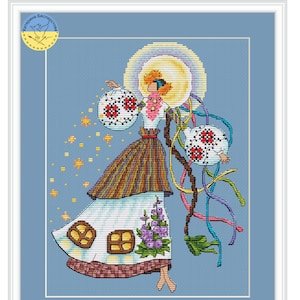May include: A cross-stitch pattern featuring a woman in a colorful dress holding two round objects with red flowers. The woman is surrounded by stars and ribbons. The background is a light blue sky.