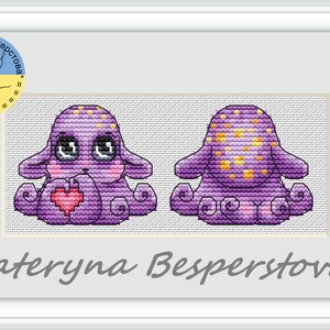 May include: Cross stitch pattern of a purple octopus holding a pink heart. The octopus has yellow spots and big eyes. The pattern is by Kateryna Besperstova.