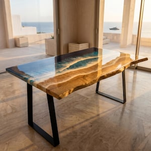 May include: A rectangular dining table featuring a natural live-edge wood slab combined with a blue and white resin inlay that mimics ocean waves. The table is supported by two black metal U-shaped legs, creating a stable base for the wood surface.