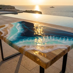 May include: A rectangular table featuring a live edge wood slab combined with blue and turquoise resin art that mimics ocean waves crashing onto a sandy shore. The table is supported by black metal legs and has a glossy, reflective surface finish.