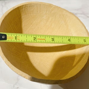 May include: A light brown, round, paper bowl with a textured surface. The bowl is 5 inches in diameter.