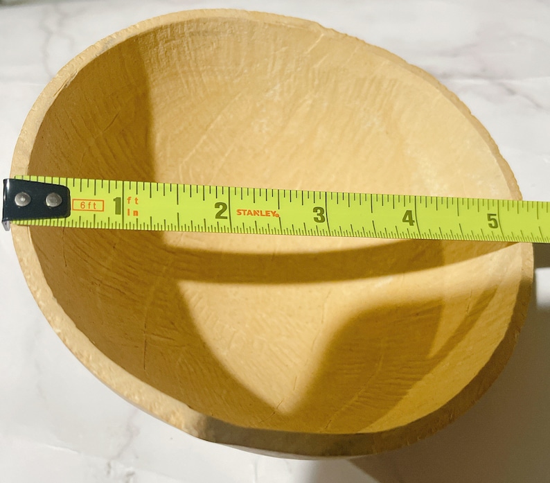 May include: A light brown, round, paper bowl with a textured surface. The bowl is 5 inches in diameter.
