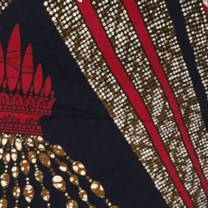 May include: A navy blue fabric with a repeating pattern of white and brown beads, red lines, and white and brown teardrop shapes.