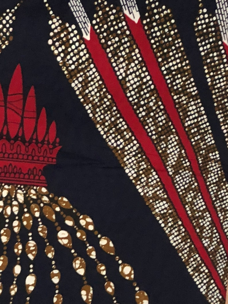 May include: A navy blue fabric with a repeating pattern of white and brown beads, red lines, and white and brown teardrop shapes.