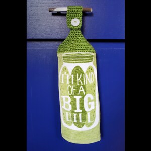 May include: Green kitchen towel with a crocheted loop for hanging. The towel features a white jar with green pickles and the text "I'm kind of a big dill".