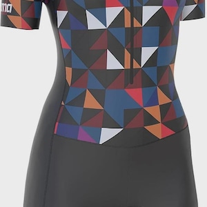 May include: A one-piece cycling suit with a geometric pattern in shades of blue, red, orange, and white. The suit has a black lower portion and a zipper down the front. The brand name "Sikma" is visible on the chest.